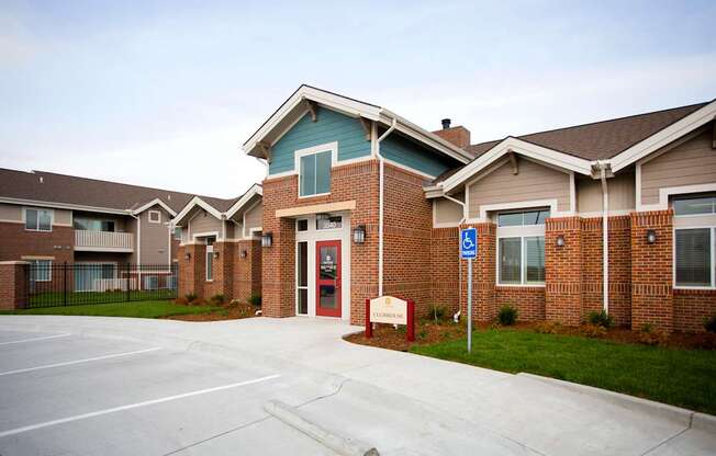 A parking lot in front of a building with a sign that says "Welcome to the community.".