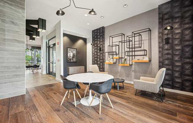 A modern dining room with a white table and chairs.