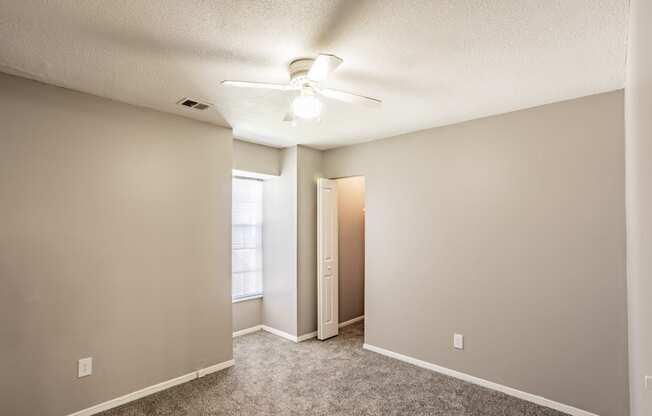 Bedroom with window and ceiling fan