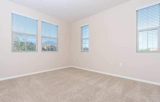 a bedroom with three windows