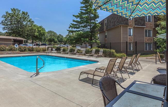 Swimming pool with lounge seating at Bristol Pointe Apartments in Olathe, Kansas.