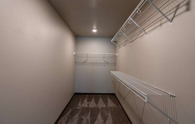 a walk in closet with shelves. Fargo, ND Granger Court Apartments.