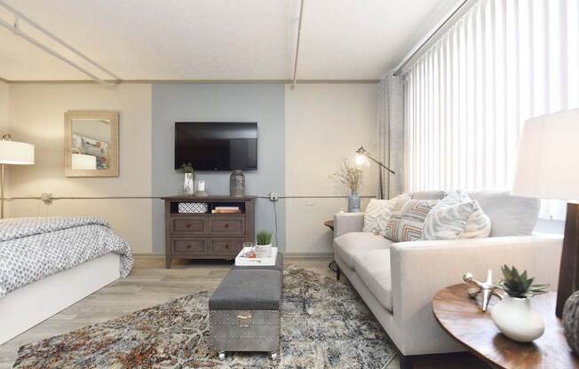 living room area with large window and vertical blinds