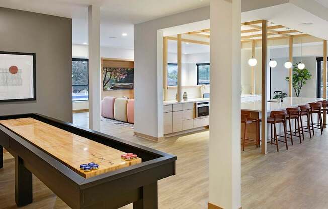 A room with a pool table and a framed picture on the wall.