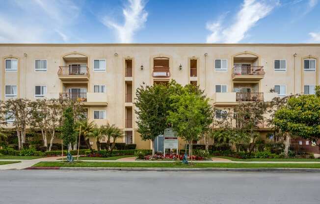 a large apartment building with trees in front of it