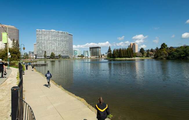 A person in a yellow jacket is standing by a body of water.