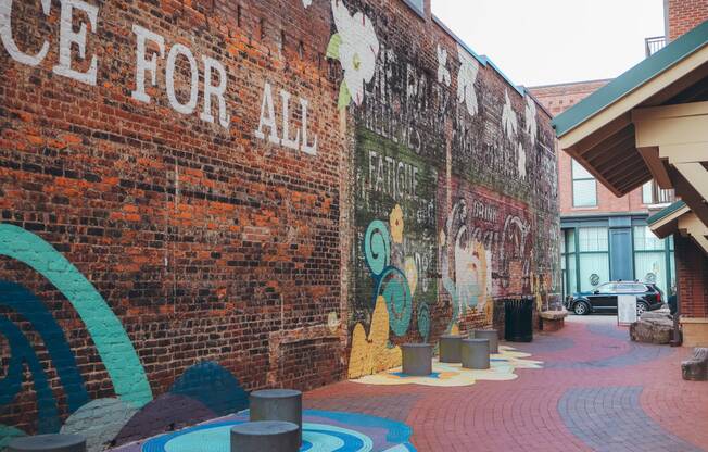 the side of a brick building with graffiti on it