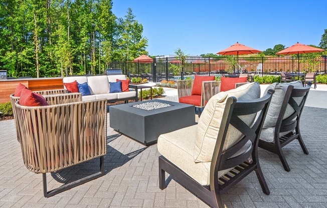 a patio with chairs and tables and umbrellas