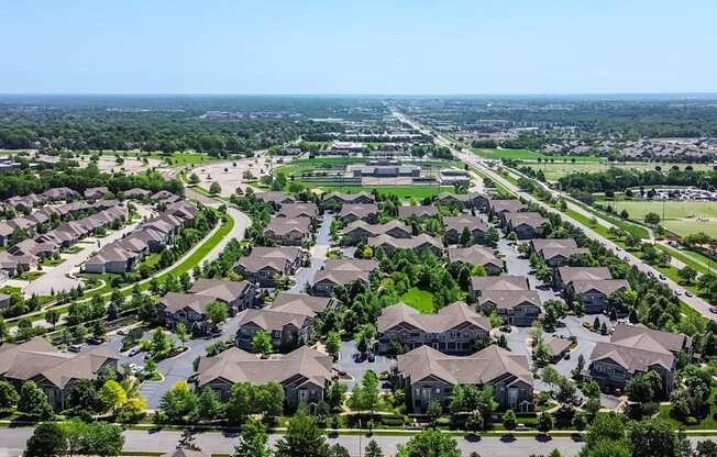 A suburban neighborhood with rows of houses and a clear sky.
