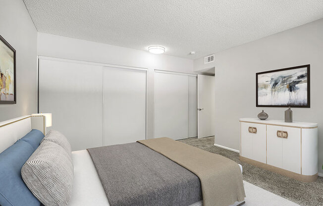 Large carpeted private bedroom showing sliding door closets.