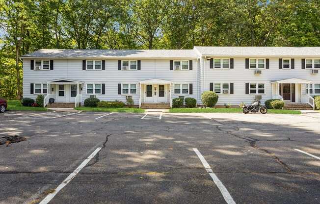 The white exterior with a parking lot in front of it at Fox Hill Commons, Connecticut, 06066