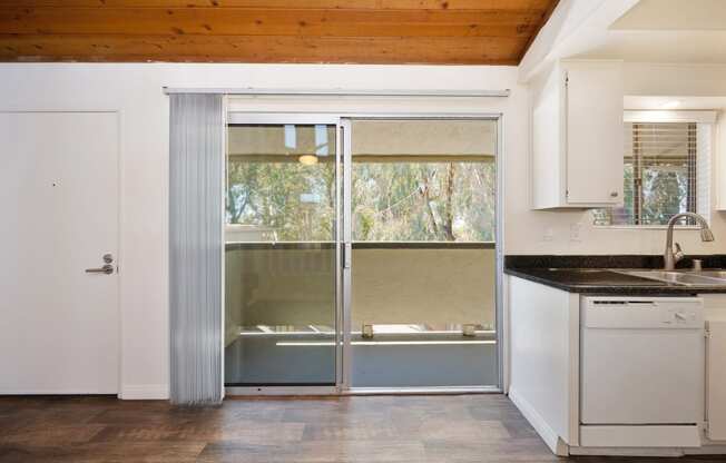 a kitchen with a sink and a sliding glass door