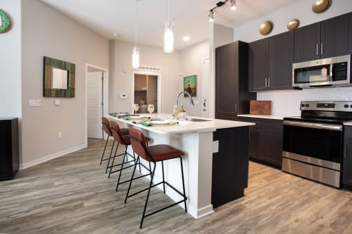 a kitchen with a white island and black cabinets
