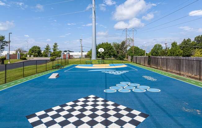 a basketball court in a park with a basketball hoop on the ground