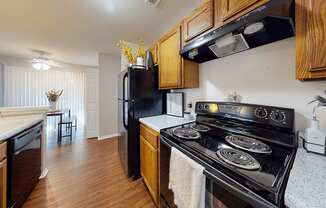 a kitchen with black appliances and wooden cabinets