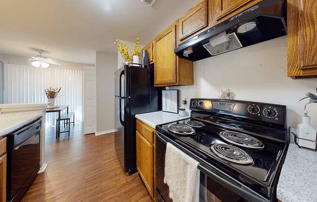 a kitchen with black appliances and wooden cabinets