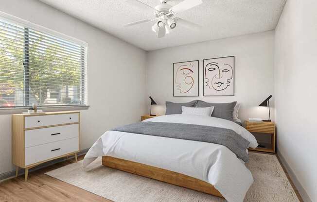 A bedroom with a bed, nightstands, and a ceiling fan.