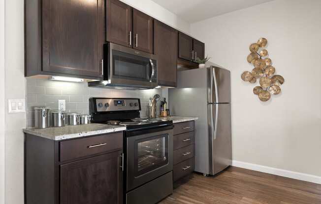 a kitchen with stainless steel appliances and wooden cabinets