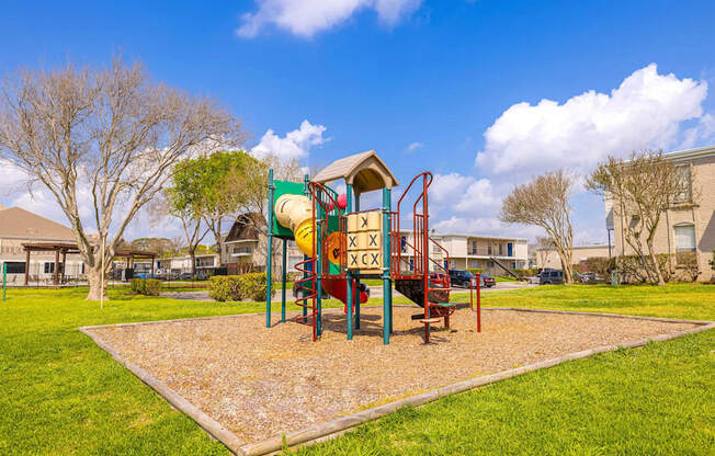 A playground with a slide and a swing set.