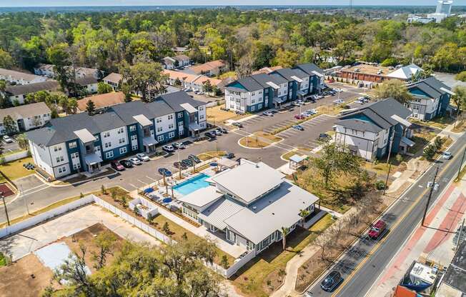 arial view of a neighborhood of houses with a pool in the middle of the road