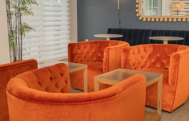 a group of orange chairs and tables in a room