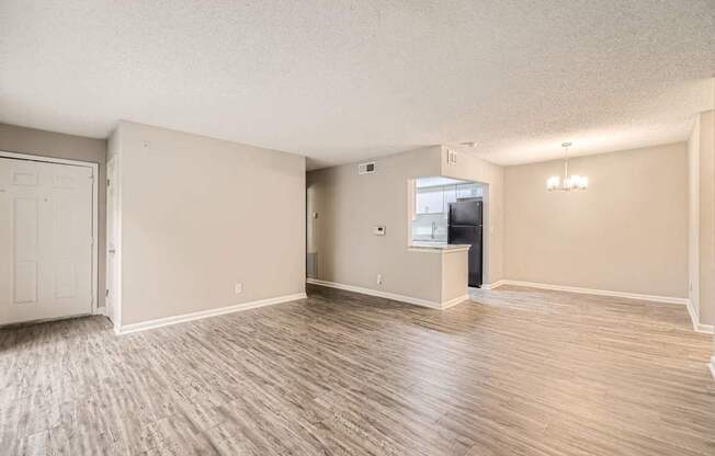 A spacious room with wood flooring and a television.