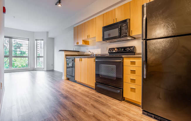 A kitchen with wooden cabinets and stainless steel appliances.