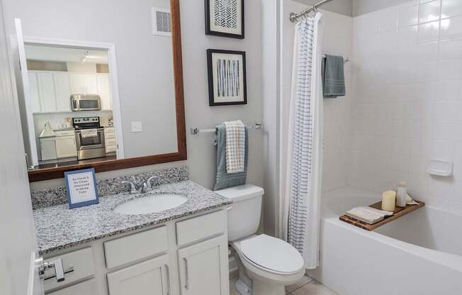 A bathroom with a toilet, sink, and bathtub.