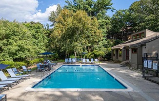 a swimming pool in the backyard of a house with a resort style pool