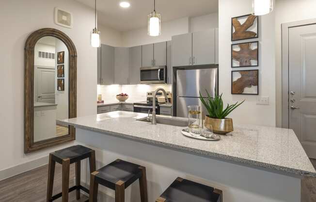 a kitchen with a granite counter top and stools