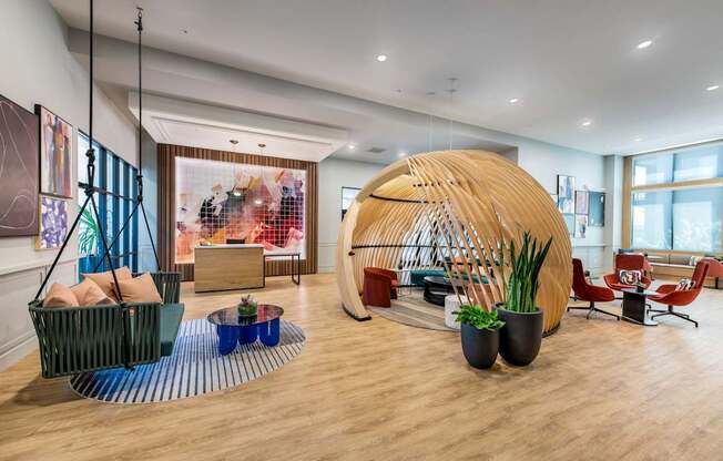 the lobby of a hotel with a large pod in the center