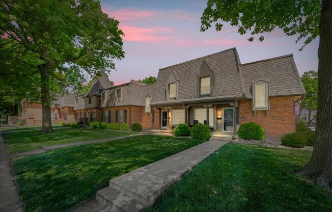 A house with a brick facade and a large front yard.