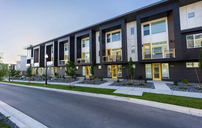 A modern building with black and white exterior and yellow doors.