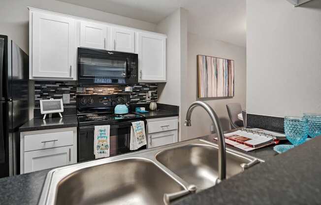 A kitchen with a stove, oven, and microwave.