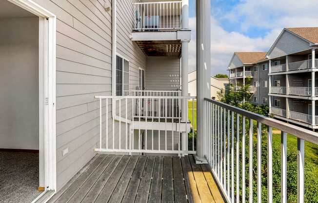 the deck has a view of the condo building and the yard