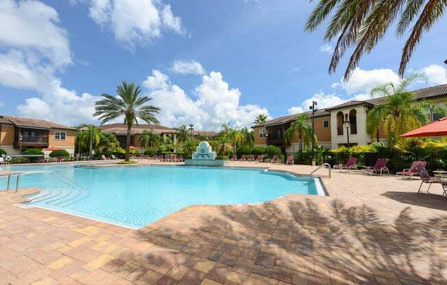 a large swimming pool with a fountain in front of a building  at Hacienda Club, Jacksonville