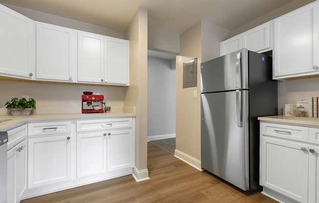a kitchen with white cabinets and a stainless steel refrigerator at Padonia Village Apartments, Timonium MD
