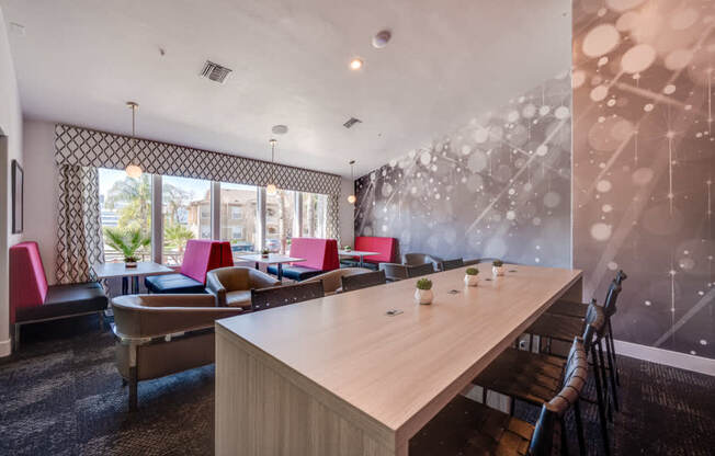 A conference room with a long table and chairs.