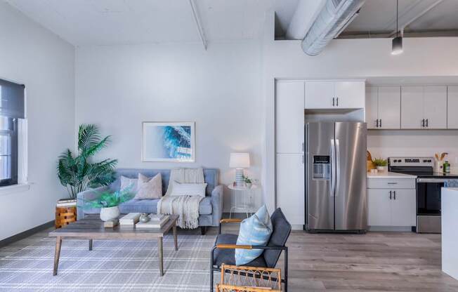A modern living room with a grey couch and a coffee table.