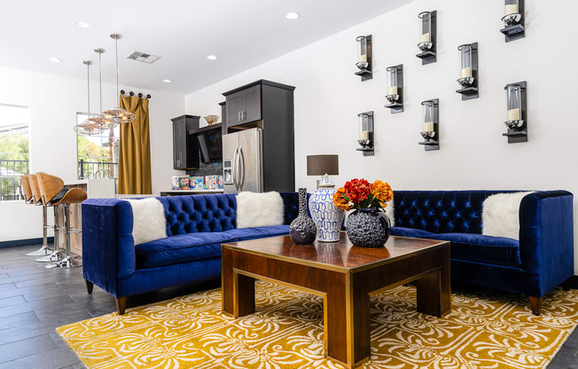 a living room with blue couches and a table