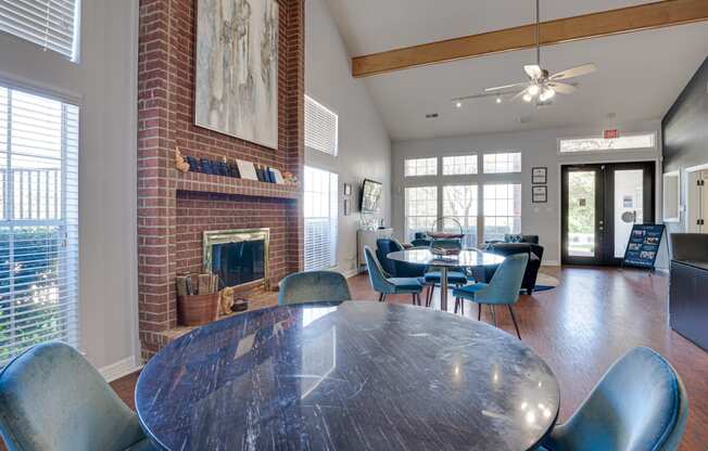 a dining room with a table and chairs and a fireplace