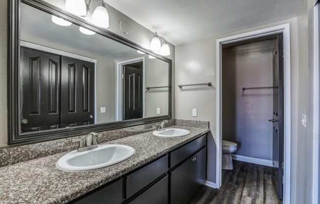 bathroom with granite countertops and side by side sink