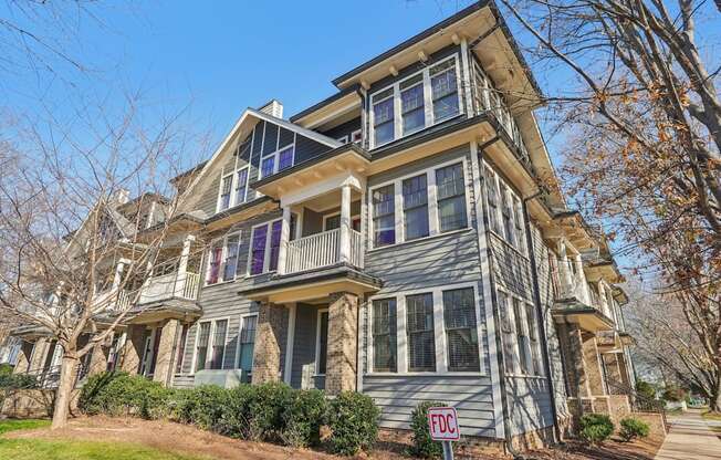 A two-story house with a balcony on the second floor.
