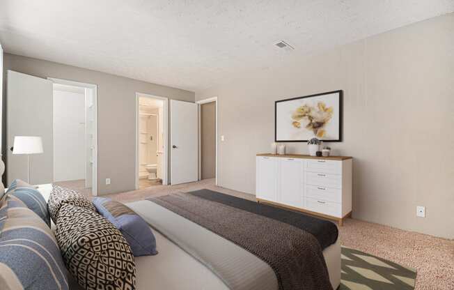 Omaha, NE Evergreen Terrace Apartments. A bedroom with a bed and a dresser