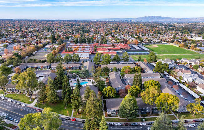 A view of a town from above with a red building in the center.