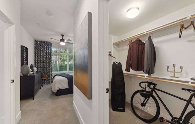 A bedroom with a bicycle in the corner.