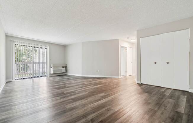 A room with wooden floors and white walls.
