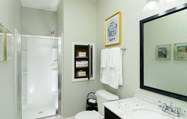 A bathroom with a toilet, sink, and shower.