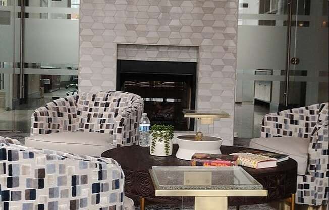 A modern living room with a fireplace and a chandelier.