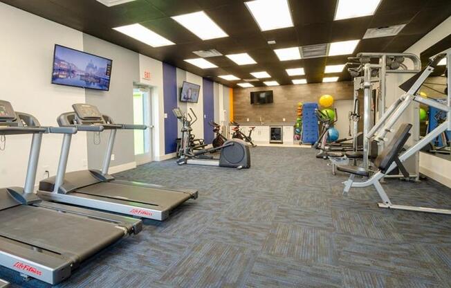 a gym with treadmills and other exercise equipment